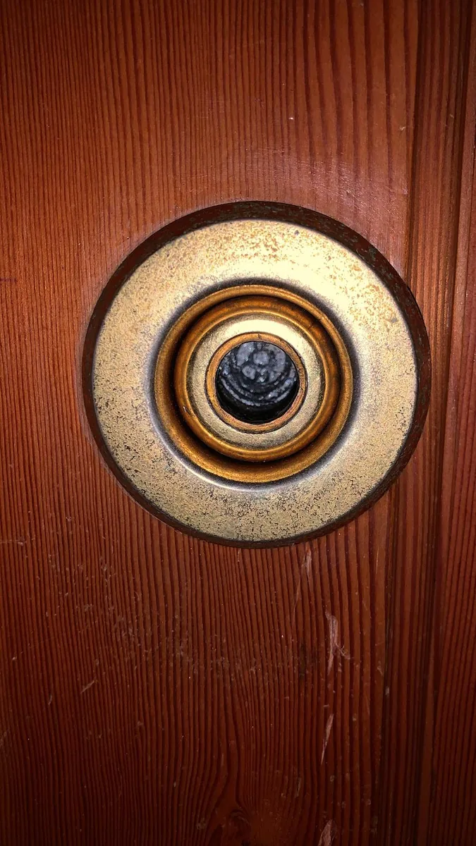 Escudo de seguridad montado en una puerta de madera